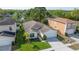 Aerial shot of a single Gathering home, showcasing the manicured lawn and surrounding neighborhood at 307 Balmoral Ct, Davenport, FL 33896