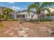 Backyard with screened pool, patio, and lush tropical landscaping at 307 Balmoral Ct, Davenport, FL 33896