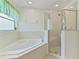 Bright bathroom boasts a corner soaking tub, and walk in shower at 307 Balmoral Ct, Davenport, FL 33896