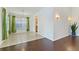 Inviting dining area featuring tile flooring, an adjacent kitchen, and hardwood flooring at 307 Balmoral Ct, Davenport, FL 33896