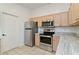 Well-equipped kitchen featuring modern appliances, ample counter space, and adjacent doorway at 307 Balmoral Ct, Davenport, FL 33896