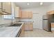 Bright kitchen with marble countertops, stainless steel appliances, and ample cabinet space at 307 Balmoral Ct, Davenport, FL 33896