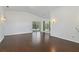 Bright and airy living room featuring hardwood floors, vaulted ceilings, and modern lighting at 307 Balmoral Ct, Davenport, FL 33896