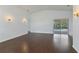 Bright living room featuring hardwood floors and sliding glass doors to the pool area at 307 Balmoral Ct, Davenport, FL 33896