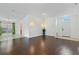 Spacious living room with hardwood floors, white walls, and a view of the front door at 307 Balmoral Ct, Davenport, FL 33896