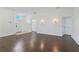 Inviting living room featuring hardwood floors, neutral walls, and a welcoming front entrance at 307 Balmoral Ct, Davenport, FL 33896