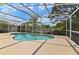 Sparkling in-ground pool with screened enclosure and lush landscaping at 307 Balmoral Ct, Davenport, FL 33896