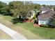 Aerial view of the neighborhood with tree coverage, and a walkway leading up to the front of the house at 3071 Shoal Creek Village Dr, Lakeland, FL 33803