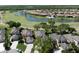 Overhead view showcases homes bordering a golf course, complete with lush landscaping and serene water features at 3071 Shoal Creek Village Dr, Lakeland, FL 33803