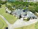 Stunning aerial view of a golf course community clubhouse with pristine greens and lush landscaping at 3071 Shoal Creek Village Dr, Lakeland, FL 33803