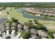 Scenic aerial view of luxury homes nestled along a golf course and a tranquil lake at 3071 Shoal Creek Village Dr, Lakeland, FL 33803
