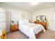Sunlit bedroom with a queen bed, wooden furnishings, and minimalist decor, creating a serene and inviting space at 3071 Shoal Creek Village Dr, Lakeland, FL 33803