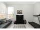 Cozy bedroom featuring a comfortable seating area, treadmill, and ample natural light at 3071 Shoal Creek Village Dr, Lakeland, FL 33803