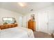 Cozy bedroom with neutral tones, featuring a queen bed, wood furnishings, and plenty of natural light at 3071 Shoal Creek Village Dr, Lakeland, FL 33803