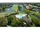 Overhead view of a heart-shaped pool, golf course and waterfront homes, creating an idyllic community setting at 3071 Shoal Creek Village Dr, Lakeland, FL 33803