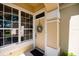 Close-up of front door with wreath, sidelight windows, and inviting entryway with colorful accents at 3071 Shoal Creek Village Dr, Lakeland, FL 33803