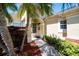 Charming front entrance with a decorative wreath on the door and lush tropical landscaping at 3071 Shoal Creek Village Dr, Lakeland, FL 33803