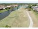 Picturesque golf course view with manicured greens, a meandering path, and luxury homes nearby at 3071 Shoal Creek Village Dr, Lakeland, FL 33803