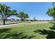 Lush green golf course next to luxury homes under a clear blue sky and shady trees at 3071 Shoal Creek Village Dr, Lakeland, FL 33803