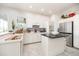 Bright kitchen with white cabinetry, a black granite island, and stainless steel appliances at 3071 Shoal Creek Village Dr, Lakeland, FL 33803
