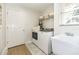 Bright laundry room features washer, dryer, utility sink, and ample storage space at 3071 Shoal Creek Village Dr, Lakeland, FL 33803