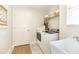 Bright laundry room with tile floors and modern washer and dryer, enhancing home convenience at 3071 Shoal Creek Village Dr, Lakeland, FL 33803
