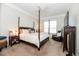 Spacious main bedroom with plush carpet, complemented by a stylish four-poster bed and seating at 3071 Shoal Creek Village Dr, Lakeland, FL 33803