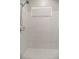 Tiled shower stall with a shower head and white, hexagonal tiled floor at 3071 Shoal Creek Village Dr, Lakeland, FL 33803