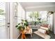Cozy sunroom with neutral tones, filled with potted plants, comfortable seating, and ample natural light at 3071 Shoal Creek Village Dr, Lakeland, FL 33803