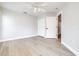 A bedroom with light wood floors, a ceiling fan, a closet, and white walls at 3080 Westmoreland Dr, Lakeland, FL 33810