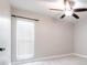 This bedroom features a ceiling fan, carpet, and a large window at 3080 Westmoreland Dr, Lakeland, FL 33810
