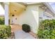 Close-up of charming home exterior with a covered porch, decorative plants, and an attached garage at 3080 Westmoreland Dr, Lakeland, FL 33810