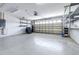 Empty two car garage with painted walls, a rolling door, shelving, and overhead lighting at 3080 Westmoreland Dr, Lakeland, FL 33810
