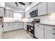 Stylish kitchen with white cabinets, granite countertops, stainless steel appliances, and modern lighting at 3080 Westmoreland Dr, Lakeland, FL 33810