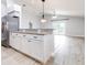 Open kitchen design with white cabinets, granite countertops, stainless steel appliances, and breakfast bar at 3080 Westmoreland Dr, Lakeland, FL 33810
