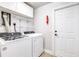 Laundry room with washer and dryer, white shelving, and a fire extinguisher at 3080 Westmoreland Dr, Lakeland, FL 33810