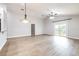 Spacious living room with light wood floors, vaulted ceilings, and sliding doors to the outside at 3080 Westmoreland Dr, Lakeland, FL 33810