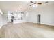 Open-concept living space with light wood floors, kitchen, and a dining area at 3080 Westmoreland Dr, Lakeland, FL 33810