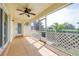 Screened-in patio with ceiling fan, a screen door, and tropical plants outside at 3080 Westmoreland Dr, Lakeland, FL 33810