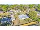 Home's location is showcased from above, with lush trees, neighboring houses, and blue sky at 3134 Hilltop S Ave, Lakeland, FL 33803