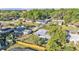 This aerial shot highlights the property's placement in a neighborhood with large trees and fenced yards at 3134 Hilltop S Ave, Lakeland, FL 33803