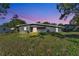 The backyard reveals the home's exterior, offering an open and spacious green area at 3134 Hilltop S Ave, Lakeland, FL 33803