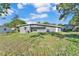 Large backyard with a well-maintained lawn and mature trees, offering a serene outdoor space at 3134 Hilltop S Ave, Lakeland, FL 33803