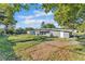 A view of the backyard features a grassy lawn, and provides a glimpse of a neighboring home at 3134 Hilltop S Ave, Lakeland, FL 33803