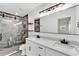 Modern bathroom with a double sink vanity, large mirror, and marble-tiled walk-in shower at 3134 Hilltop S Ave, Lakeland, FL 33803