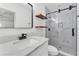 Modern bathroom featuring a sleek vanity, stylish shelving, and a glass-enclosed shower with elegant tiling at 3134 Hilltop S Ave, Lakeland, FL 33803