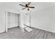 Bright bedroom with ceiling fan, closet, and modern gray flooring, offering a cozy and stylish living space at 3134 Hilltop S Ave, Lakeland, FL 33803