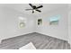 Bright bedroom with three windows and modern gray flooring, providing ample natural light and a cozy feel at 3134 Hilltop S Ave, Lakeland, FL 33803