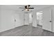 Spacious bedroom with modern gray flooring, showcasing multiple doorways and access to an ensuite bathroom at 3134 Hilltop S Ave, Lakeland, FL 33803