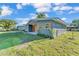 Modern single-story home with natural wood accents, tidy landscaping and a well maintained lawn at 3134 Hilltop S Ave, Lakeland, FL 33803